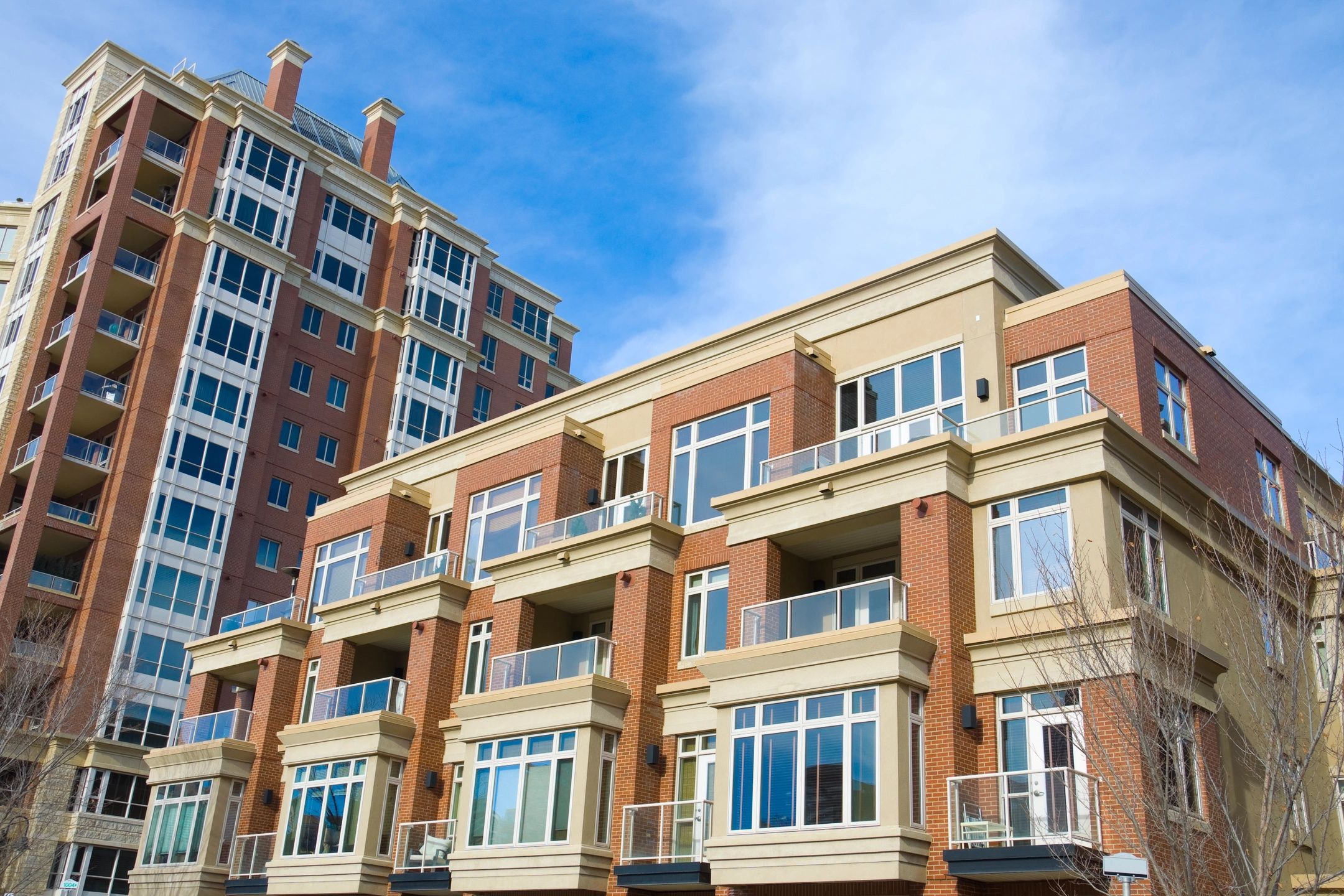 Modern apartment buildings under clear blue sky.